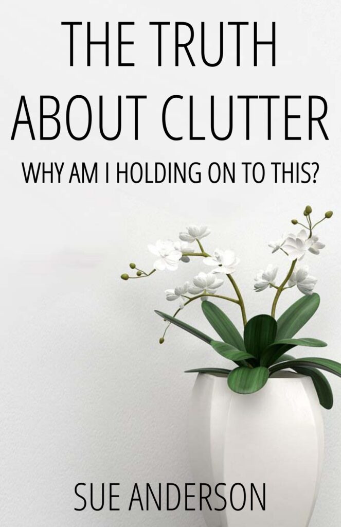 Book cover of The Truth About Clutter: a plant with green leaves and white flowers in a white vessel, in front of a white wall.